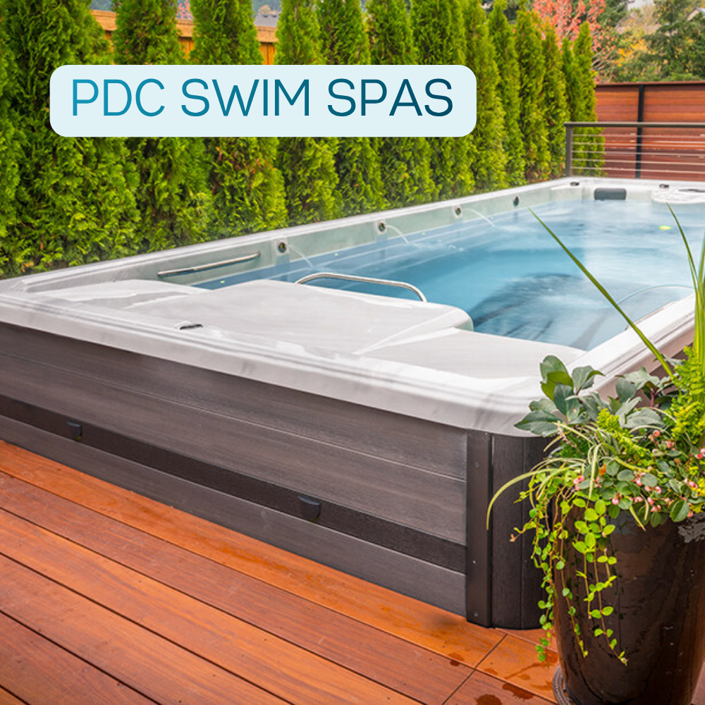 PDC swim spa installed on a deck with surrounding greenery and privacy hedge