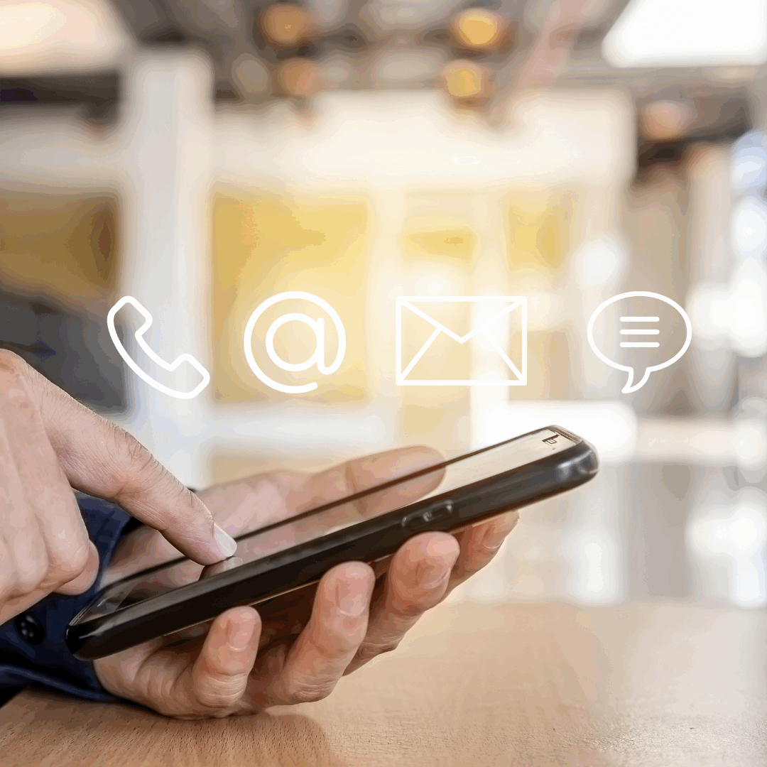Contact us photo of a phone glowing with a phone, email, mail, and chat icon above it
